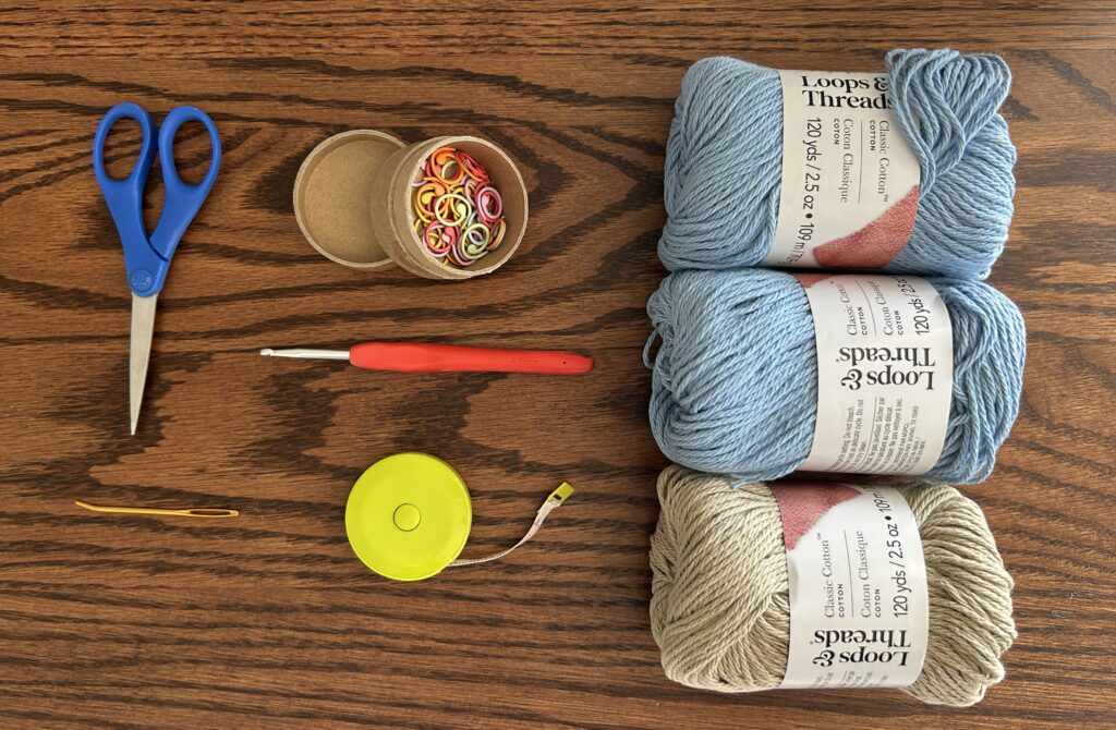 Crochet Materials for a Bucket Hat sitting on a dark wooden surface