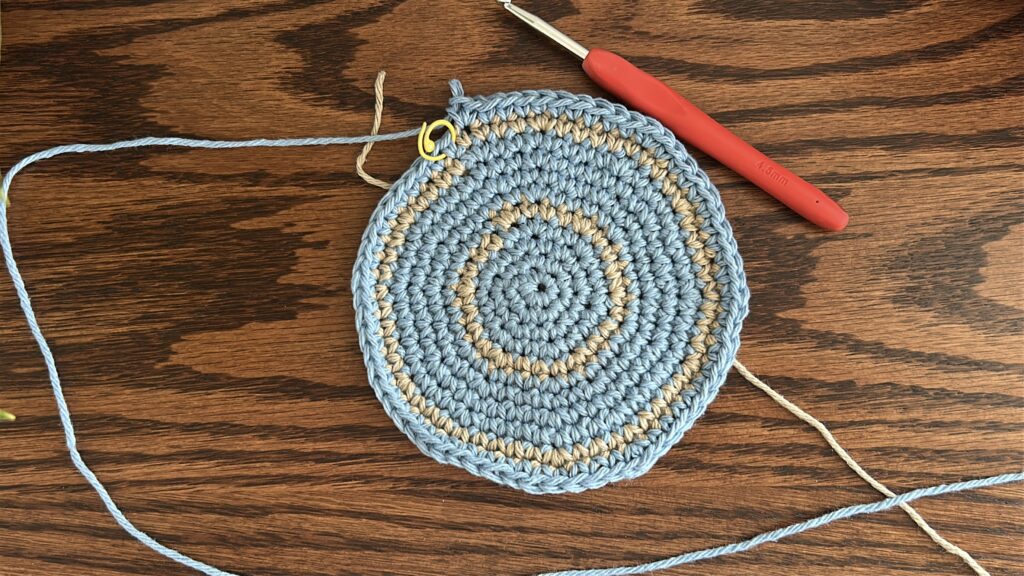 Blue cotton yarn round after second crochet stripe along bucket hat