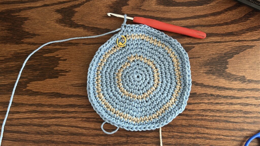 Crochet bucket hat body worked in blue cotton yarn