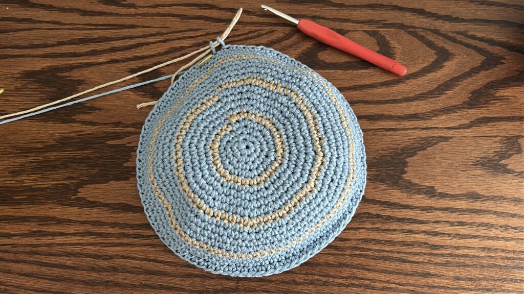 Crochet bucket hat body worked in brown cotton yarn, single crochet rounds