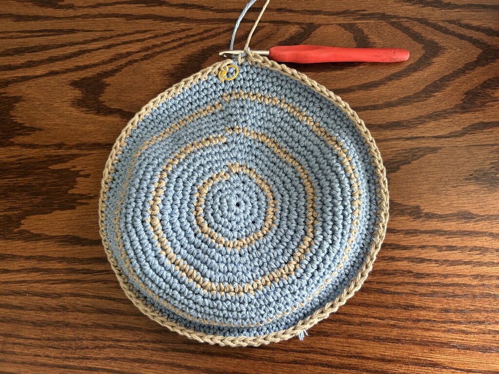 Crochet bucket hat body worked in brown cotton yarn, single crochet rounds, after fourth stripe