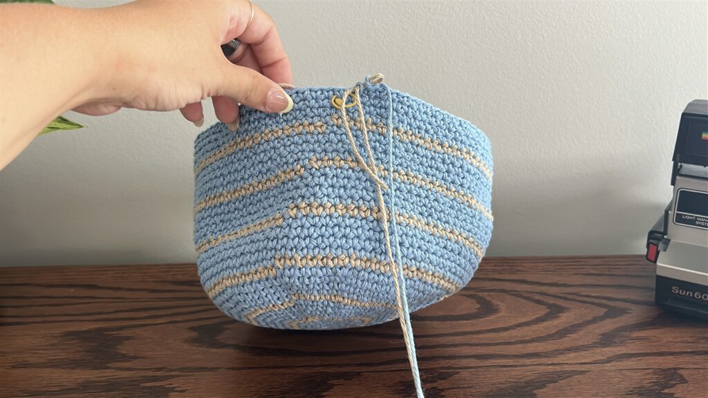 Single crochet round on crochet bucket hat in blue cotton yarn