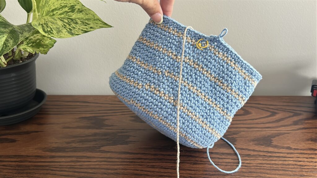 Crochet bucket hat working increases to create the brim with blue cotton yarn