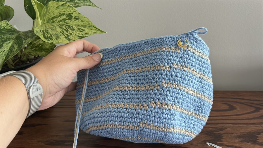 Brim of crochet bucket hat forming with crochet increases in blue cotton yarn