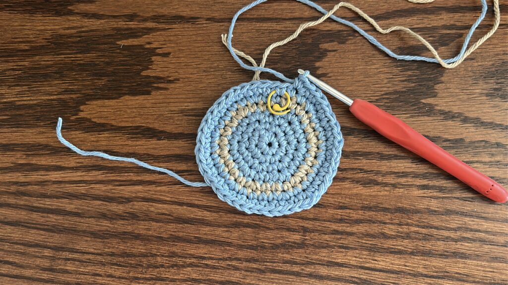 Striped crochet bucket hat after round seven of the pattern